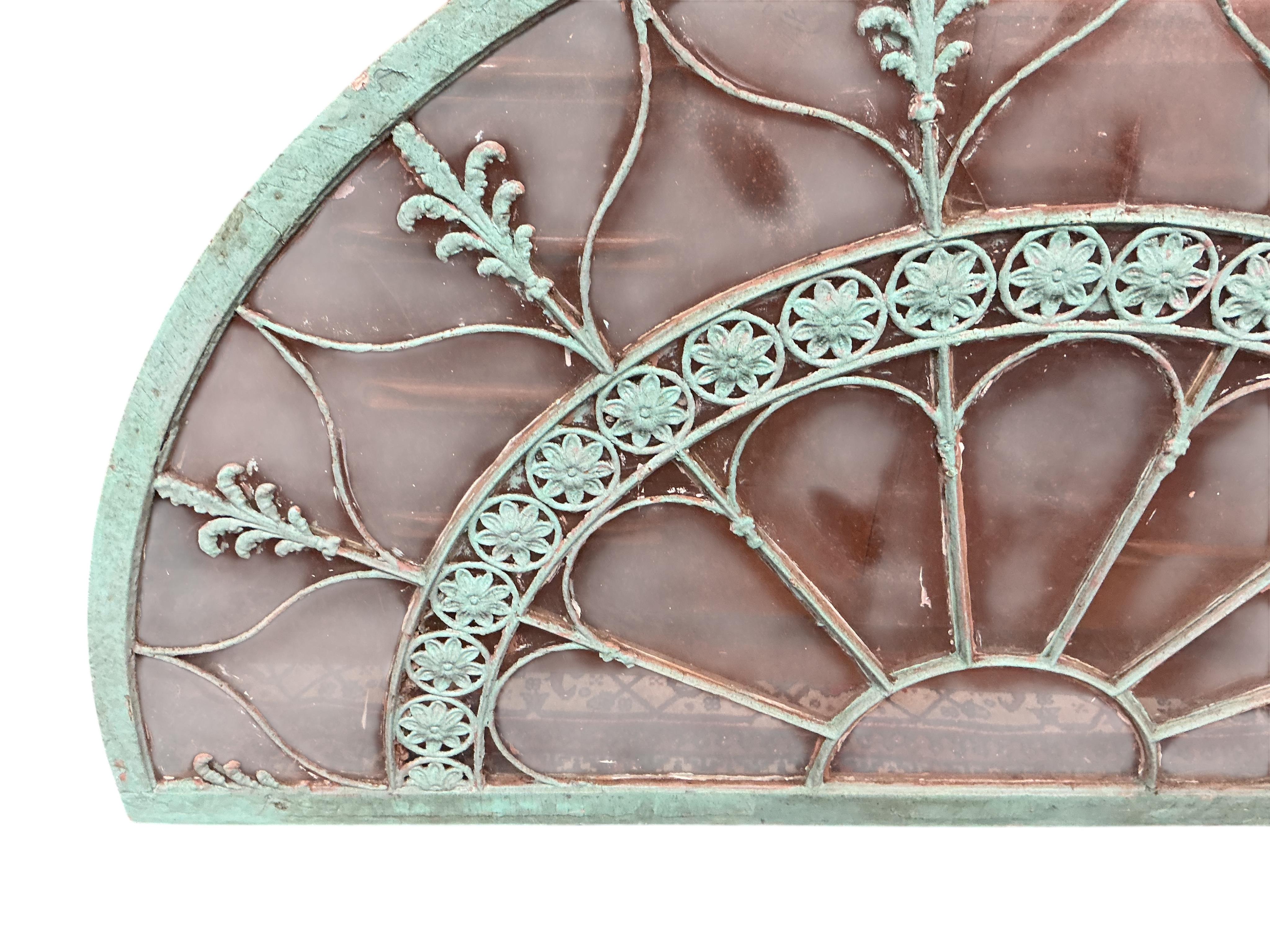 A 19th century wood and wrought iron fan light, later painted, width 170cm, height 91cm